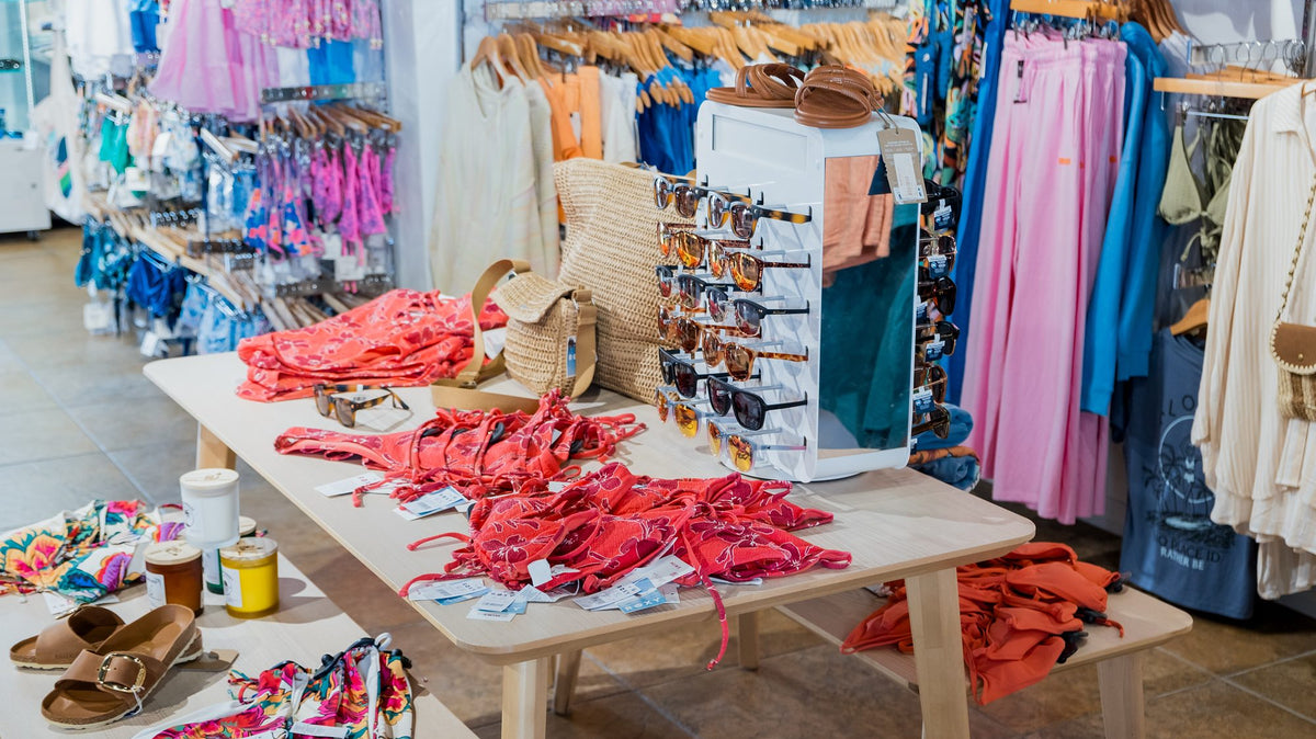Swimwear table and racks of colorful swimsuits at Swim City Downtown Sarasota