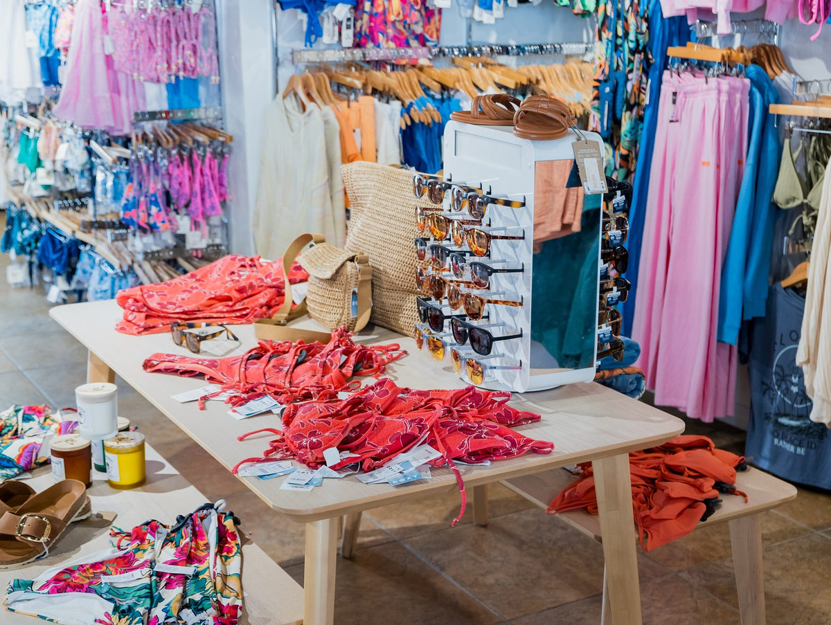 Swimwear table and racks of colorful swimsuits at Swim City Downtown Sarasota
