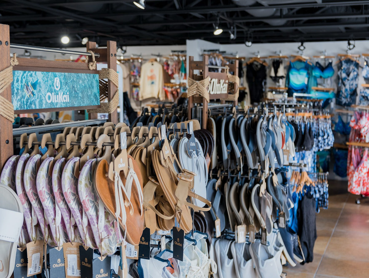 OluKai sandal display with branded signage at Swim City in downtown Sarasota