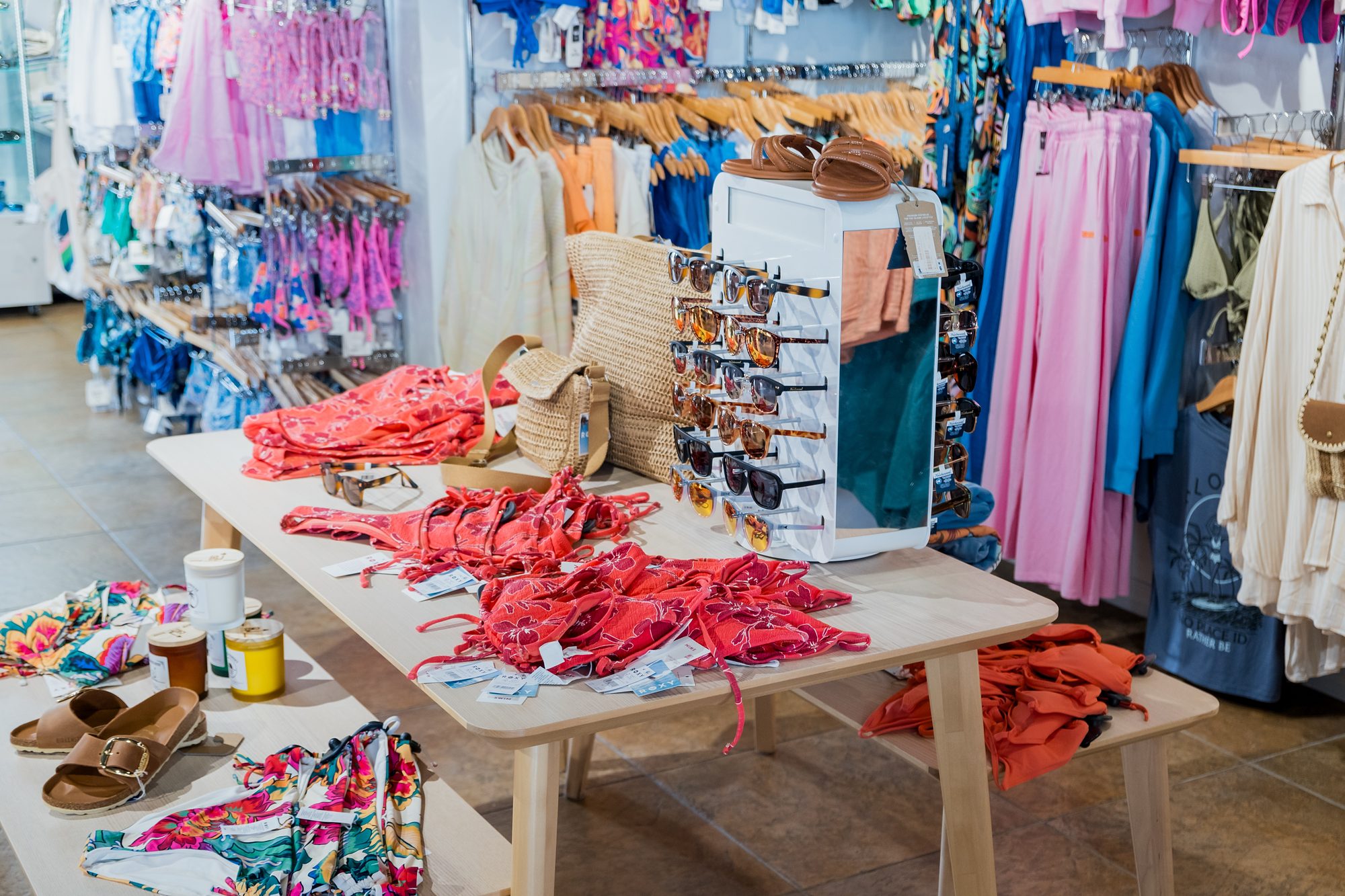 Swimwear table and racks of colorful swimsuits at Swim City Downtown Sarasota