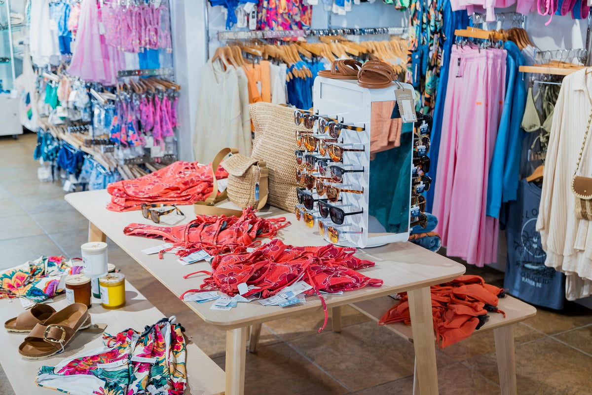 Swimwear table and racks of colorful swimsuits at Swim City Downtown Sarasota