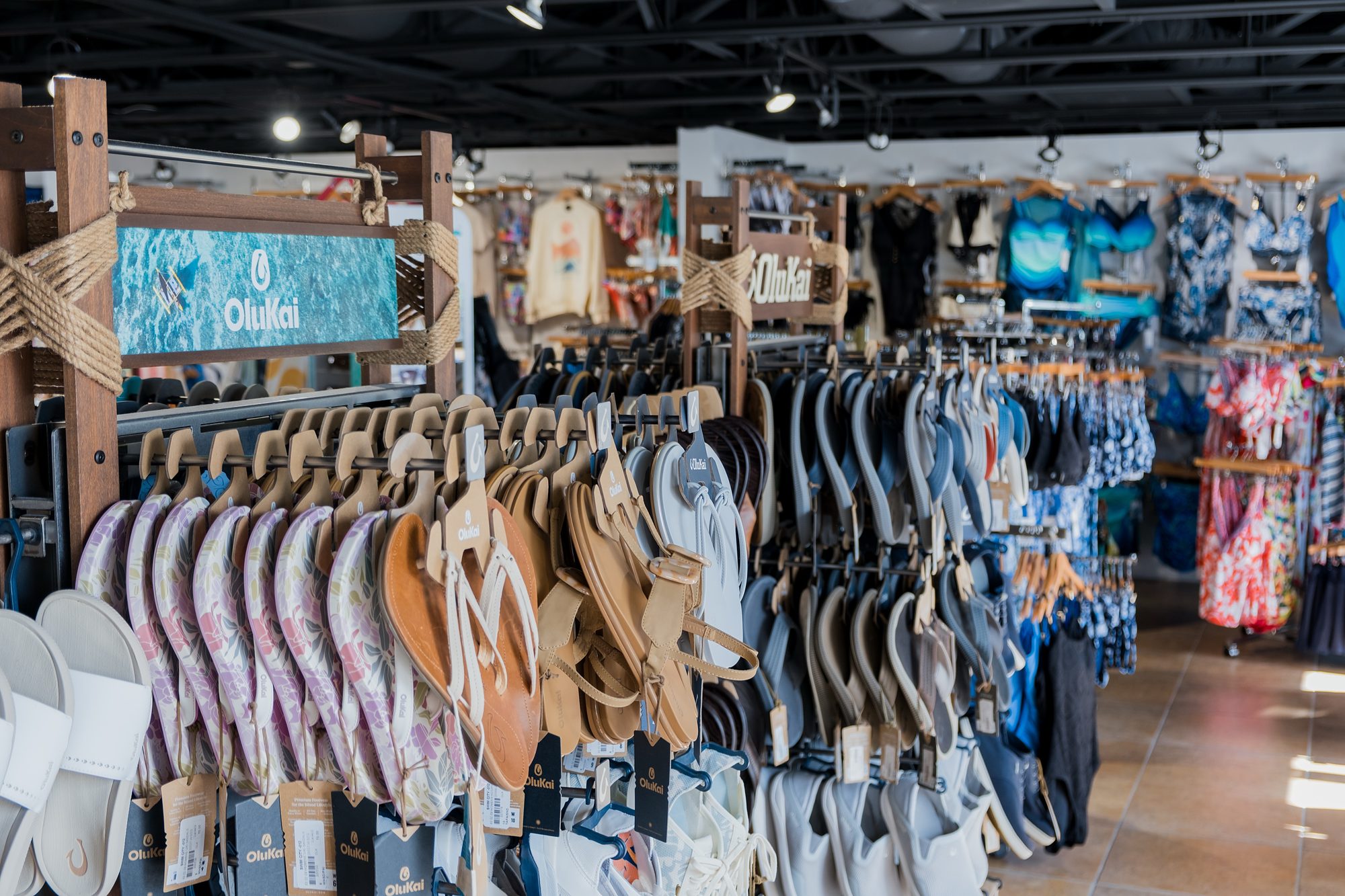 OluKai sandal display with branded signage at Swim City in downtown Sarasota